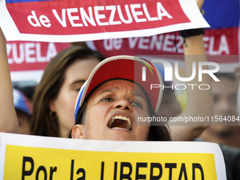 Venezuelans living in Spain take part in a gathering outside the Spanish parliament in support of opposition presidential candidate Edmundo...