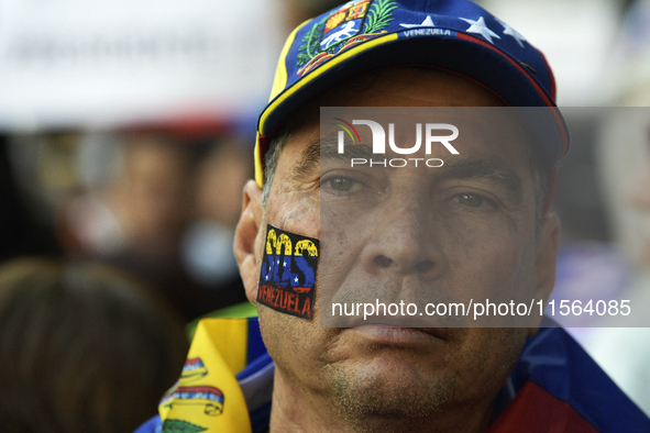 Venezuelans living in Spain take part in a gathering outside the Spanish parliament in support of opposition presidential candidate Edmundo...