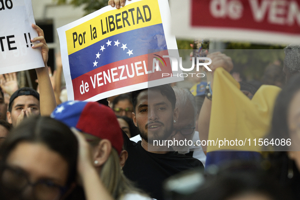 Venezuelans living in Spain take part in a gathering outside the Spanish parliament in support of opposition presidential candidate Edmundo...