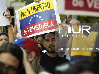 Venezuelans living in Spain take part in a gathering outside the Spanish parliament in support of opposition presidential candidate Edmundo...