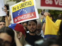 Venezuelans living in Spain take part in a gathering outside the Spanish parliament in support of opposition presidential candidate Edmundo...