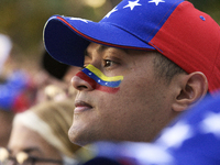 Venezuelans living in Spain take part in a gathering outside the Spanish parliament in support of opposition presidential candidate Edmundo...