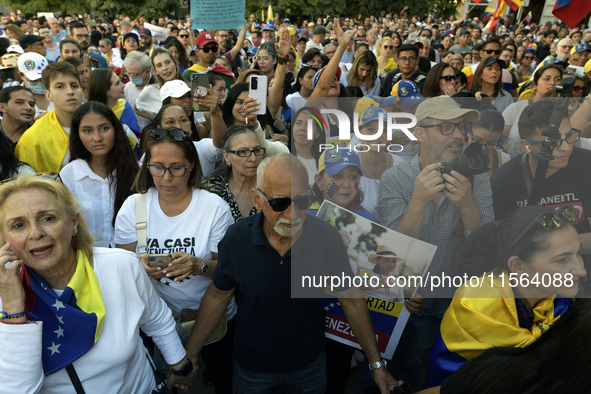 Venezuelans living in Spain take part in a gathering outside the Spanish parliament in support of opposition presidential candidate Edmundo...