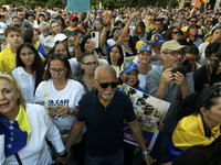 Venezuelans living in Spain take part in a gathering outside the Spanish parliament in support of opposition presidential candidate Edmundo...