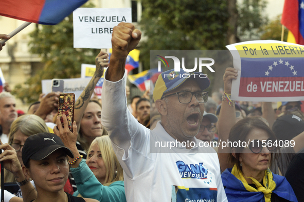 Venezuelans living in Spain take part in a gathering outside the Spanish parliament in support of opposition presidential candidate Edmundo...