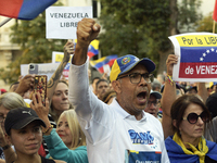 Venezuelans living in Spain take part in a gathering outside the Spanish parliament in support of opposition presidential candidate Edmundo...