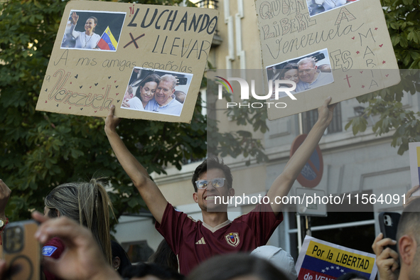 Venezuelans living in Spain take part in a gathering outside the Spanish parliament in support of opposition presidential candidate Edmundo...