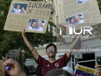 Venezuelans living in Spain take part in a gathering outside the Spanish parliament in support of opposition presidential candidate Edmundo...