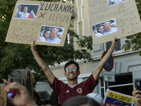 Venezuelans living in Spain take part in a gathering outside the Spanish parliament in support of opposition presidential candidate Edmundo...