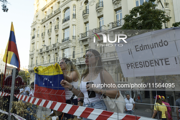 Venezuelans living in Spain take part in a gathering outside the Spanish parliament in support of opposition presidential candidate Edmundo...