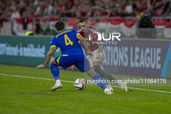 Zsolt Nagy of Hungary competes for the ball with Jusuf Gazibegovic of Bosnia and Herzegovina during the UEFA Nations League Group A3 match a...