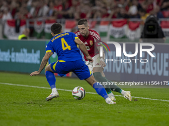 Zsolt Nagy of Hungary competes for the ball with Jusuf Gazibegovic of Bosnia and Herzegovina during the UEFA Nations League Group A3 match a...