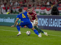 Zsolt Nagy of Hungary competes for the ball with Jusuf Gazibegovic of Bosnia and Herzegovina during the UEFA Nations League Group A3 match a...