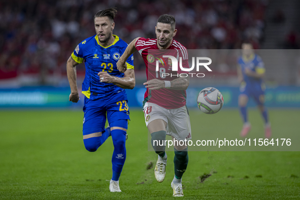 Zsolt Nagy of Hungary competes for the ball with Emin Bicakcic of Bosnia and Herzegovina during the UEFA Nations League Group A3 match at Pu...