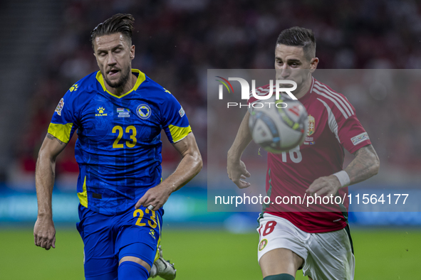 Zsolt Nagy of Hungary competes for the ball with Emin Bicakcic of Bosnia and Herzegovina during the UEFA Nations League Group A3 match at Pu...