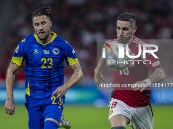 Zsolt Nagy of Hungary competes for the ball with Emin Bicakcic of Bosnia and Herzegovina during the UEFA Nations League Group A3 match at Pu...