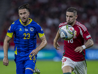 Zsolt Nagy of Hungary competes for the ball with Emin Bicakcic of Bosnia and Herzegovina during the UEFA Nations League Group A3 match at Pu...