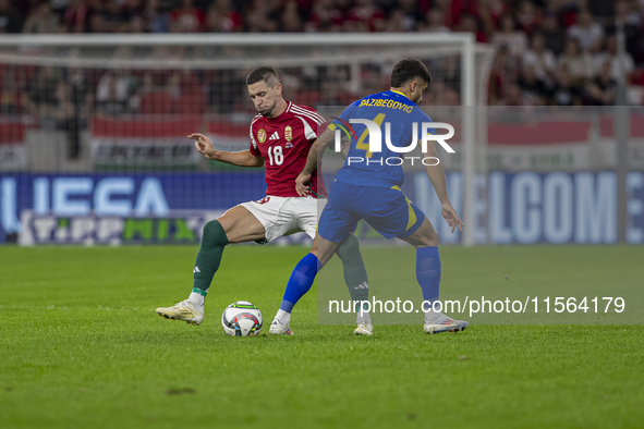 Zsolt Nagy of Hungary competes for the ball with Jusuf Gazibegovic of Bosnia and Herzegovina during the UEFA Nations League Group A3 match a...