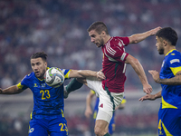 Barnabas Varga of Hungary competes for the ball with Ermin Bicakcic of Bosnia and Herzegovina during the UEFA Nations League Group A3 match...