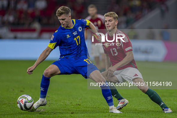 Dzenic Burnic of Bosnia and Herzegovina competes for the ball with Andras Schafer of Hungary during the UEFA Nations League Group A3 match a...