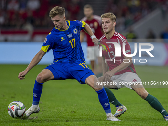 Dzenic Burnic of Bosnia and Herzegovina competes for the ball with Andras Schafer of Hungary during the UEFA Nations League Group A3 match a...