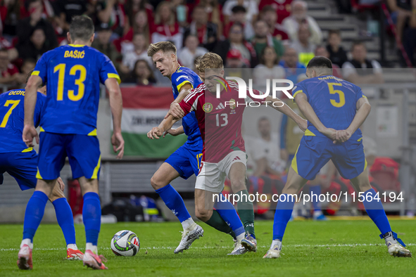 Andras Schafer of Hungary competes for the ball with Dzenis Burnic of Bosnia and Herzegovina during the UEFA Nations League Group A3 match a...