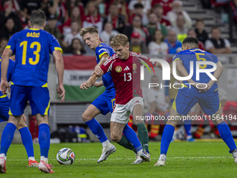 Andras Schafer of Hungary competes for the ball with Dzenis Burnic of Bosnia and Herzegovina during the UEFA Nations League Group A3 match a...