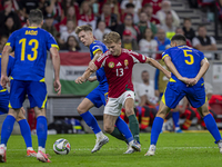 Andras Schafer of Hungary competes for the ball with Dzenis Burnic of Bosnia and Herzegovina during the UEFA Nations League Group A3 match a...