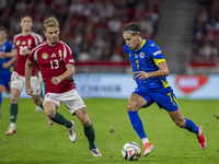 Amar Dedic of Bosnia and Herzegovina competes for the ball with Andras Schafer of Hungary during the UEFA Nations League Group A3 match at P...