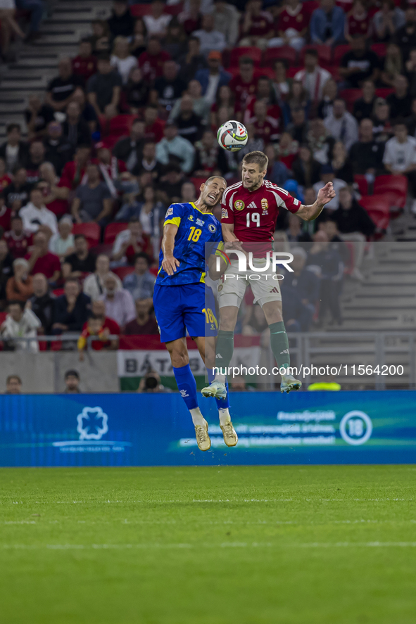 Barnabas Varga of Hungary competes for the ball with Nikola Katic of Bosnia and Herzegovina during the UEFA Nations League Group A3 match at...