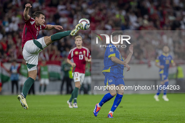 Willi Orban of Hungary competes for the ball with Armin Gigovic of Bosnia and Herzegovina during the UEFA Nations League Group A3 match at P...