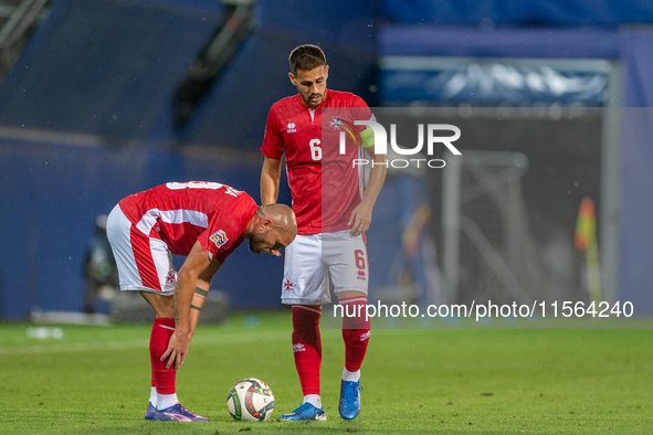 In Andorra La Vella, Andorra, on September 10, 2024, Matthew Guillaumier of Malta and Teddy Teuma of Malta are in action during the UEFA Nat...