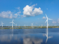 Wind turbines rotate in the wind on the coastal beaches of Yancheng City, Jiangsu Province, China, on September 10, 2024. (