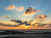 Wind turbines rotate in the wind on the coastal beaches of Yancheng City, Jiangsu Province, China, on September 10, 2024. (