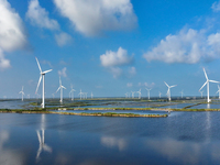 Wind turbines rotate in the wind on the coastal beaches of Yancheng City, Jiangsu Province, China, on September 10, 2024. (