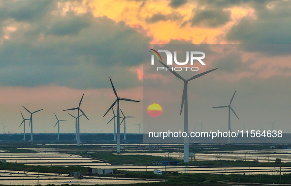 Wind turbines rotate in the wind on the coastal beaches of Yancheng City, Jiangsu Province, China, on September 10, 2024. 