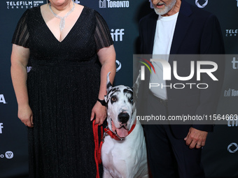 Bev Klingensmith (L) and Bill Berloni (R) pose for a photo with Bing the Dog as they attend the premiere of 'The Friend' during the 2024 Tor...