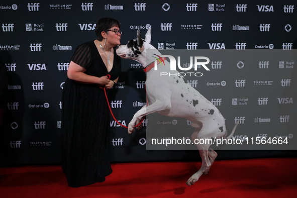 Bev Klingensmith poses for a photo with Bing the Dog as they attend the premiere of 'The Friend' during the 2024 Toronto International Film...