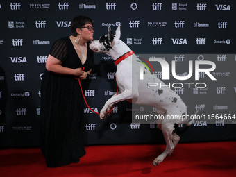 Bev Klingensmith poses for a photo with Bing the Dog as they attend the premiere of 'The Friend' during the 2024 Toronto International Film...