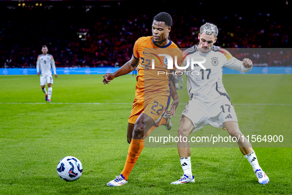 Netherlands defender Denzel Dumfries and Germany midfielder Florian Wirtz during the match between the Netherlands and Germany at the Johan...