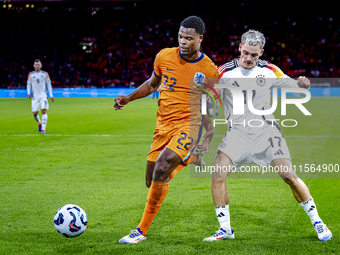 Netherlands defender Denzel Dumfries and Germany midfielder Florian Wirtz during the match between the Netherlands and Germany at the Johan...