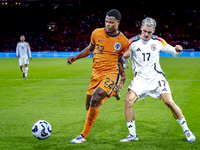 Netherlands defender Denzel Dumfries and Germany midfielder Florian Wirtz during the match between the Netherlands and Germany at the Johan...