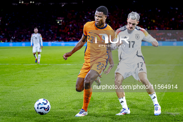 Netherlands defender Denzel Dumfries and Germany midfielder Florian Wirtz during the match between the Netherlands and Germany at the Johan...