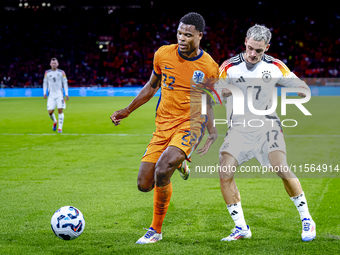 Netherlands defender Denzel Dumfries and Germany midfielder Florian Wirtz during the match between the Netherlands and Germany at the Johan...