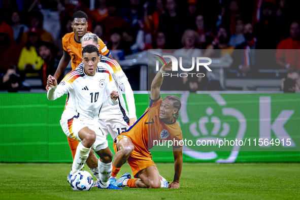 Germany midfielder Jamal Musiala and Netherlands midfielder Xavi Simons during the match between the Netherlands and Germany at the Johan Cr...