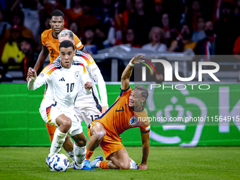 Germany midfielder Jamal Musiala and Netherlands midfielder Xavi Simons during the match between the Netherlands and Germany at the Johan Cr...