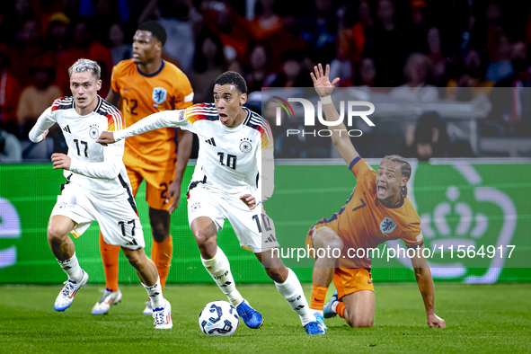 Germany midfielder Jamal Musiala and Netherlands midfielder Xavi Simons during the match between the Netherlands and Germany at the Johan Cr...