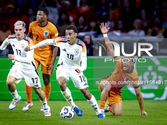 Germany midfielder Jamal Musiala and Netherlands midfielder Xavi Simons during the match between the Netherlands and Germany at the Johan Cr...