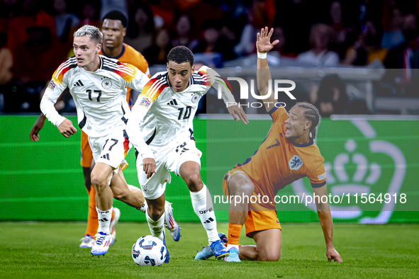 Germany midfielder Jamal Musiala and Netherlands midfielder Xavi Simons during the match between the Netherlands and Germany at the Johan Cr...