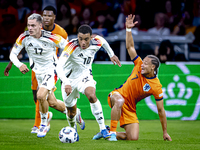 Germany midfielder Jamal Musiala and Netherlands midfielder Xavi Simons during the match between the Netherlands and Germany at the Johan Cr...